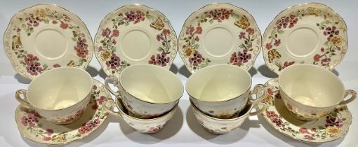 A set of six Zsolnay Pecs teacups and saucers, printed with flowers, picked out in gilt