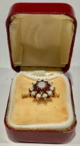 A 9ct gold opal and garnet flower head cluster ring, size N/O, London 1973, 2.9g