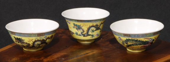 A garniture of Chinese circular bowls, each painted in polychrome enamels with dragons on a yellow