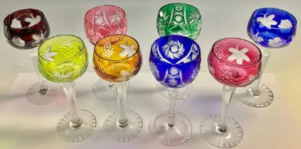 A set of five hock harlequin glasses, engraved with fruiting vine; a similar set of three slightly