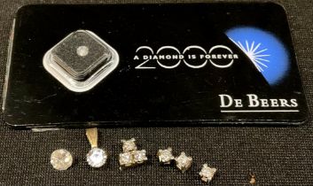 A De Beers single diamond presentation plaque, 2000 A Diamond Is Forever; a loose round brilliant