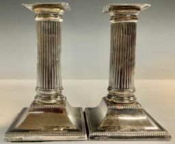 A pair of silver candlesticks, fluted columns, 13.5cm high, Sheffield 1925