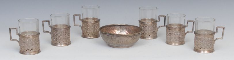 A set of six Iranian silver tea glasses, pierced and engraved with flowerhead diapers, angular