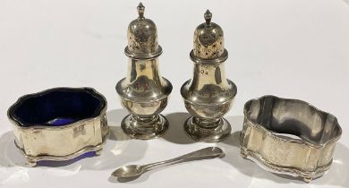 A pair of Edwardian silver baluster pepper pots, pierced star cut domed covers, spire finials,