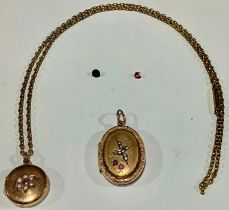 A late 19th century gold plated circular locket, set with seed pearls, suspended from a gold