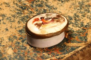 A George III South Staffordshire enamel oval patch box, hinged cover painted with a bird, pale