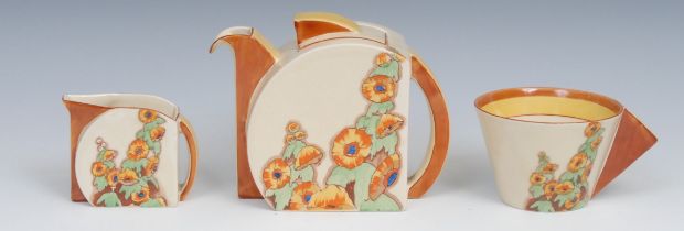 A Clarice Cliff Sunshine pattern breakfast tea service, comprising teapot, milk jug and cup, printed