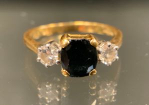 A diamond and sapphire three stone ring, central rectangular cut deep blue sapphire approx.1.50ct,