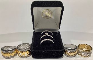 A Bradford Exchange sterling silver trilogy ring group, illusion set with diamond chips, size O, 7.