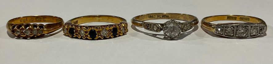 An 18ct gold and diamond five-stone ring; the large central stone flanked by four further graduating