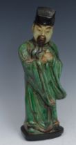 A Chinese figure, of an immortal, he stands, holding a peach, wearing a typical Ming futou, 29cm