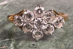 A diamond ring, lozenge crest set with nine round brilliant cut diamonds, total estimated diamond