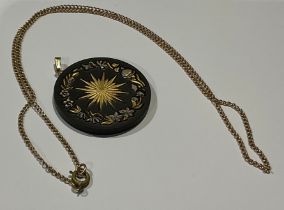 A basalt ware ceramic pendant; a gold coloured metal chain
