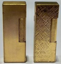 A gold plated Dunhill cigarette lighter; another (2)