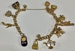 A 9ct gold charm bracelet, assorted 9ct gold charms, bear, heart, shoes, handbag, cat, etc, safety