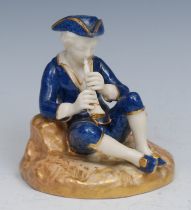 A Royal Worcester figure, of a boy seated playing a pipe, decorated in powder blue, 10cm high,