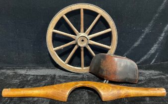 A cartwheel, metal bound with turned spokes, 46cm diameter; a milkmaid's yoke; a wooden cow bell (3)