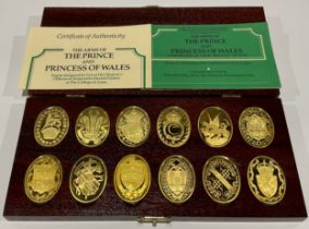 A set of 12 oval silver gilt plaques or ingots for the arms of the Prince and Princess of Whales,