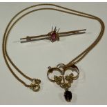 A 9ct gold rectangular bar brooch, centered with an insect set with a seed pearl and pink stone; a