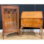 A mahogany bowfront display cabinet; a walnut bureau (2)