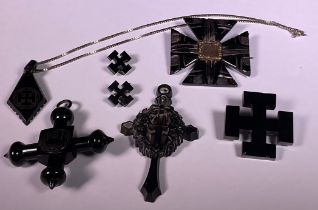 A Victorian Whitby Jet mourning brooch, set with a waxed lock of hair; an associated four piece