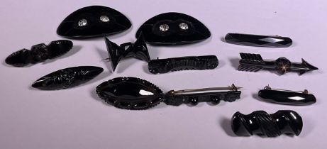 A Victorian Whitby Jet bar brooch; other similar; pair of buckles set with paste stones (12)