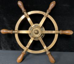 A bronze ships wheel, each of the six spokes with turned oak handle, rear fastening plate, 49cm