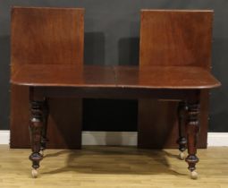 A mahogany extending dining table, rounded rectangular top with two additional leaves, turned