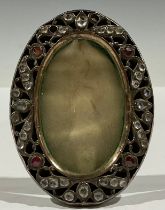 An ornate Victorian oval frame, inset with Old Cut stones