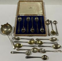 A set of six silver teaspoons, Walker & Hall, Sheffield 1960, cased; a silver tea strainer,