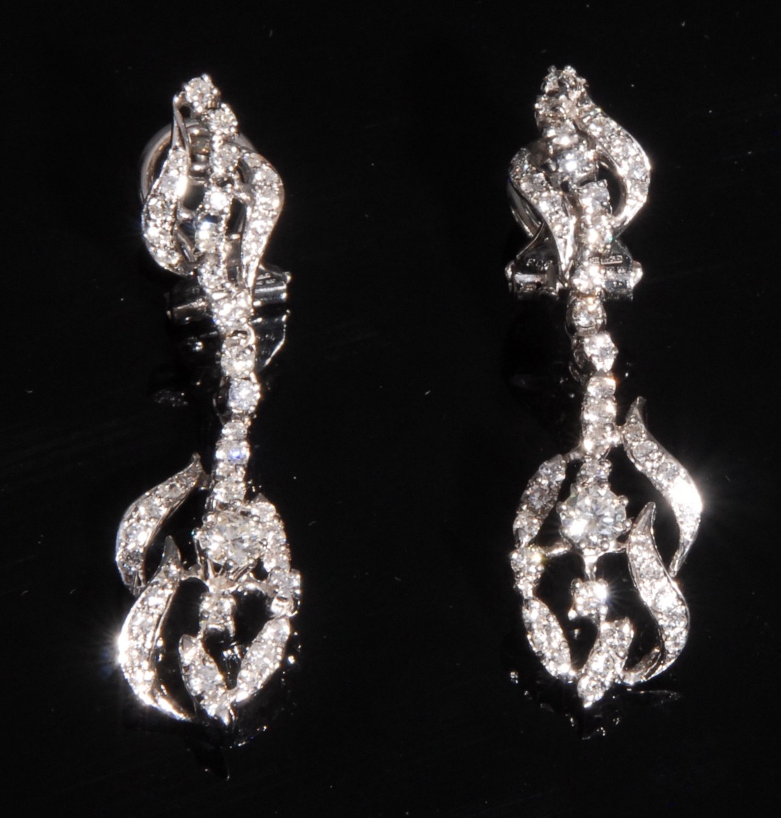 A pair of diamond pedant earrings, each set with forty five round brilliant and mixed cut