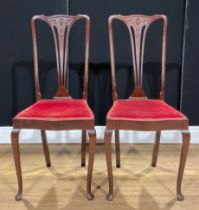 A pair of Edwardian mahogany salon chairs, carved splats, serpentine seats, red velvet upholstery,
