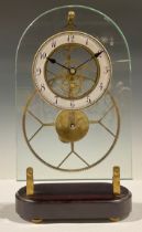 A contemporary skeleton clock, arched glass plate mounted with enamel chapter ring, Arabic numerals,