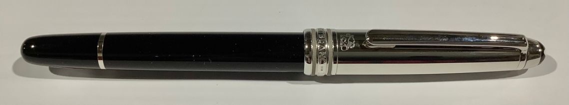 A Montblanc Meisterstuck Fountain Pen with black resin barrel and white metal cap, clip and banding,