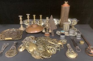 A collection of 19th century and later horse brasses, some on leather straps; a Shirley's Hecla