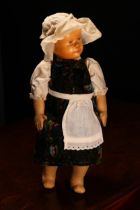 An early 20th century Swiss carved wooden head doll, probably produced in the Brienz Region by