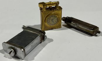 A Vintage lighter inset watch; two others
