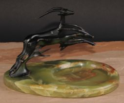 An Art Deco bronze mounted desk tidy, surmounted by a pair of streamlined stylised leaping gazelles,