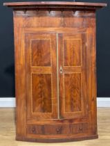 A large George III mahogany bowfront corner cupboard, 131.5cm high, 96cm wide, 56cm deep