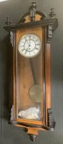 A 19th century walnut and ebonised vase, single weight wall clock