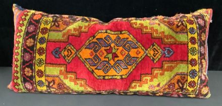 A Middle Eastern woollen floor cushion, 110cm long
