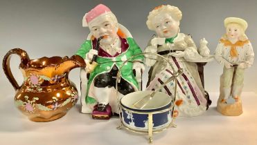A pair of late 19th century continental Darby and Joan tobacco jars and covers, he smoking a pipe,