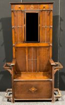An early to mid-20th century oak hall stand, hinged seat, 182.5cm high, 108cm wide, 32.5cm deep