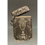A French silver coloured metal rectangular vesta case, embossed in neo-classical style, c.1910