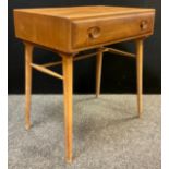 An Ercol desk, designed by Lucia’s Randolph Ercolani, c.1960, model number 437, in elm wood,