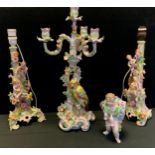 A pair of continental lamps stylized with cherubs, flowers and swirls, Parakeet candelabrum;