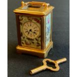 Gilt miniature porcelain cartridge clock, key wind movement, 6x3.5cm