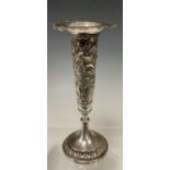 An Anglo Indian silver coloured metal trumpet vase, embossed with exotic animals inc Elephant,