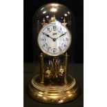 A Schatz 400 day Anniversary clock, brass stand and glass cover, 30cm high