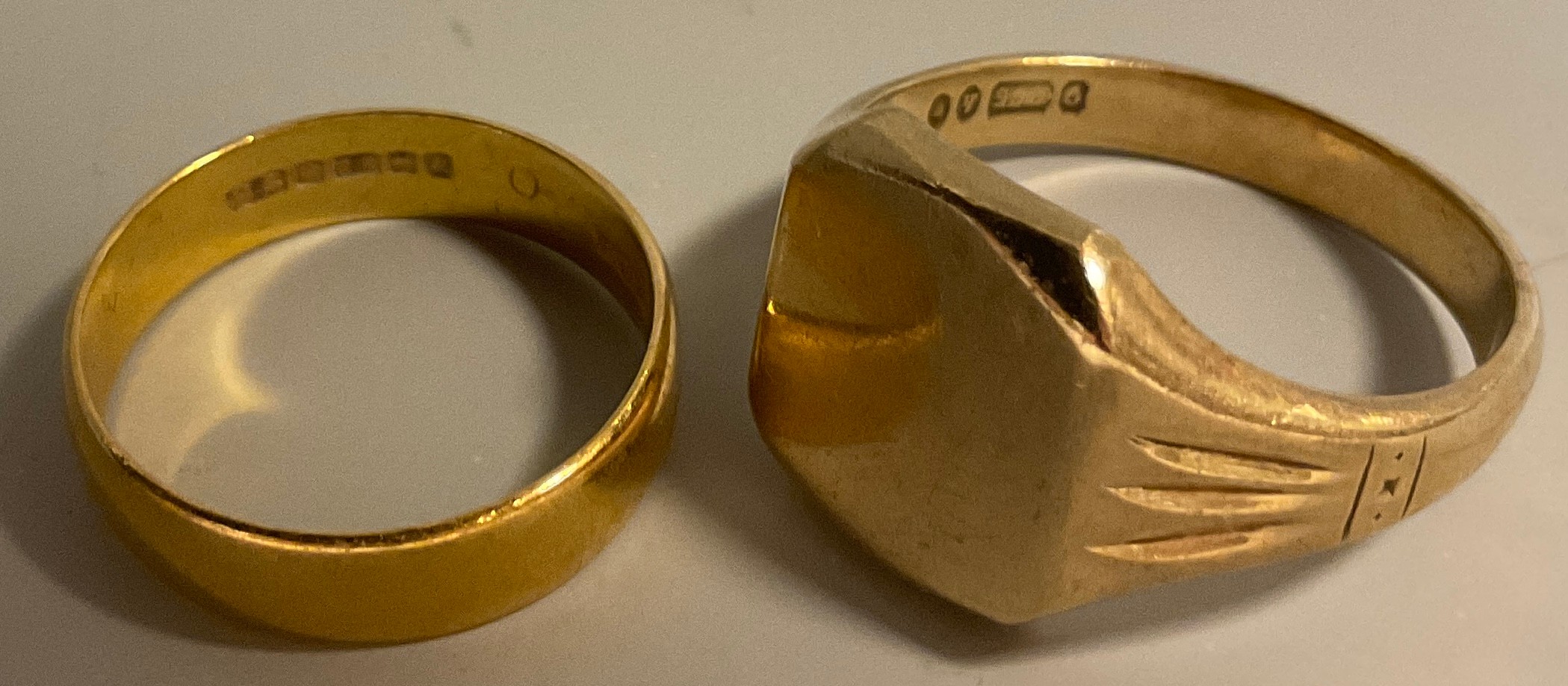 A 22ct wedding band, 3.9g; a 9ct signet ring, 8.7g.